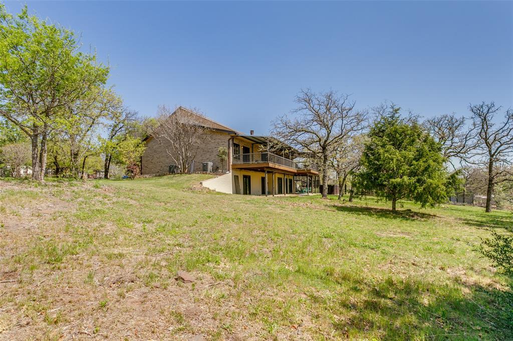 1557 Latigo Hills Road Bartonville, TX 75022 - Photo 37 of 40 View of green lawn with a deck
