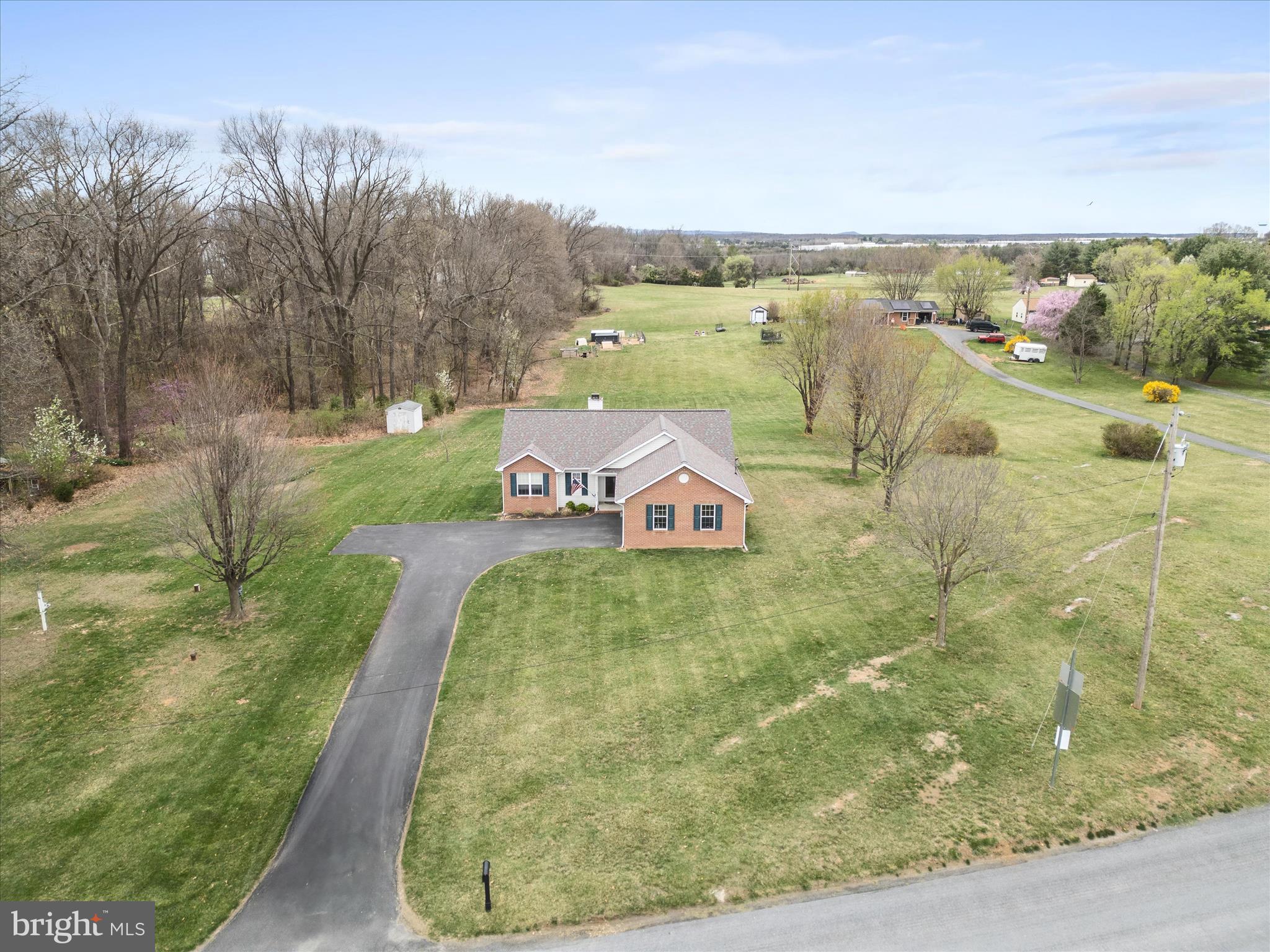 993 Rockland Road Front Royal, VA 22630 - Photo 2 of 37 a view of a lake with a yard and large trees