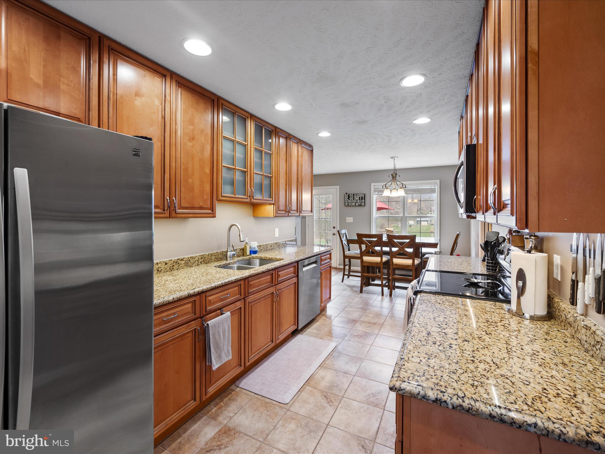 993 Rockland Road Front Royal, VA 22630 - Photo 5 of 37 a kitchen with stainless steel appliances granite countertop sink refrigerator and cabinets