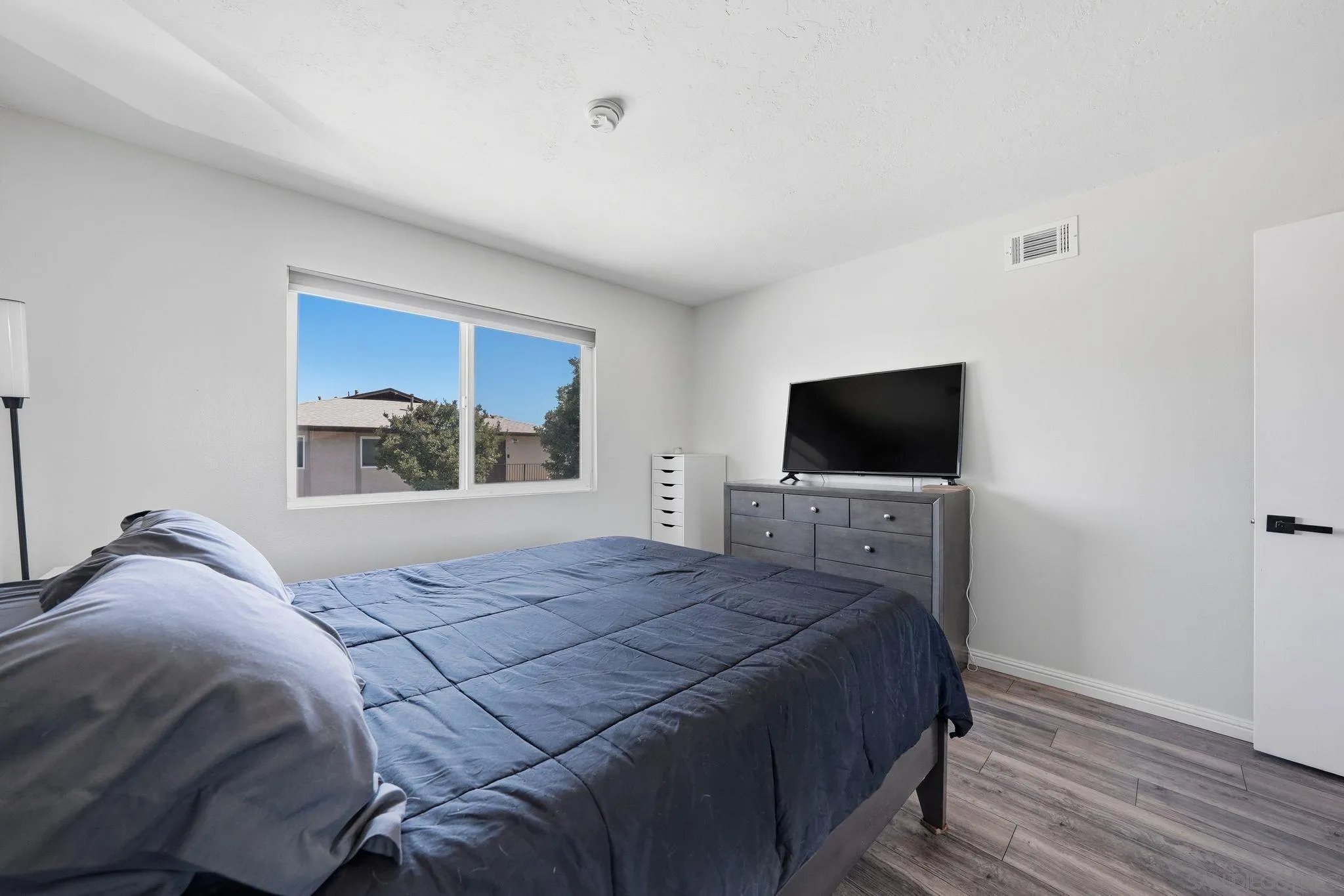 9926 Mission Vega Road, Unit 4 Santee, CA 92071 - Photo 20 of 30 a bedroom with a bed and a flat screen tv