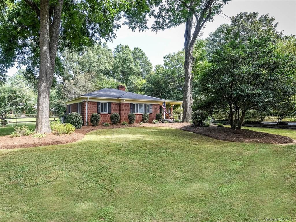 4419 Castleton Road Charlotte, NC 28211 - Photo 2 of 24 a front view of a house with a garden
