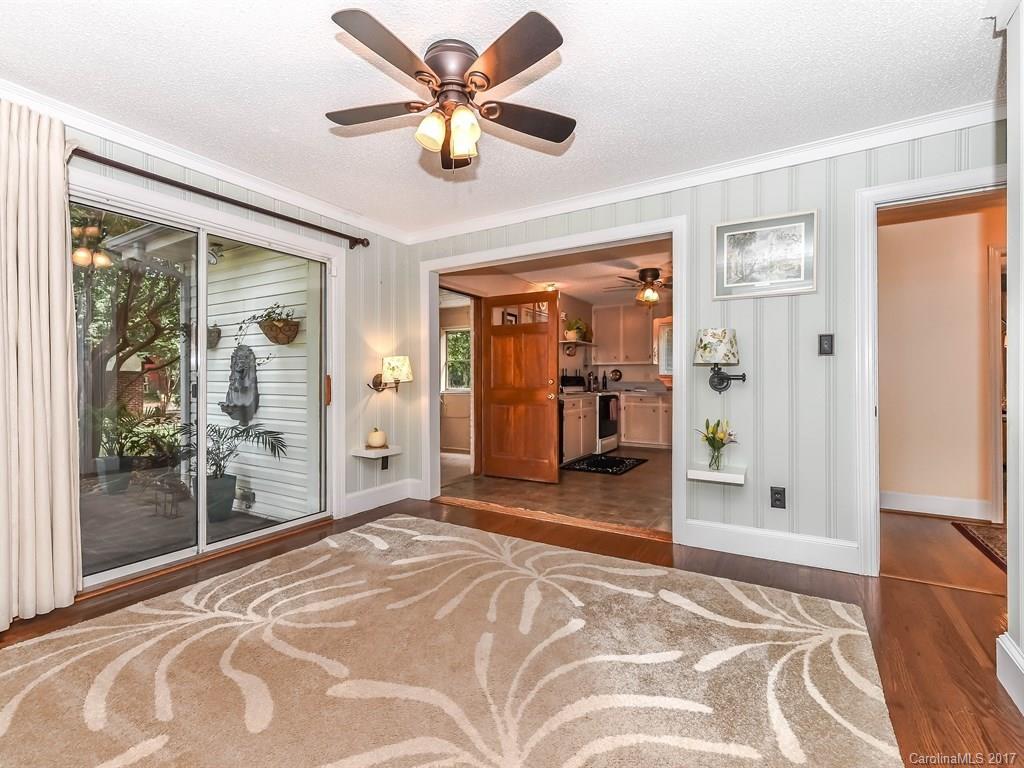 4419 Castleton Road Charlotte, NC 28211 - Photo 13 of 24 a view of a livingroom with wooden floor and a ceiling fan