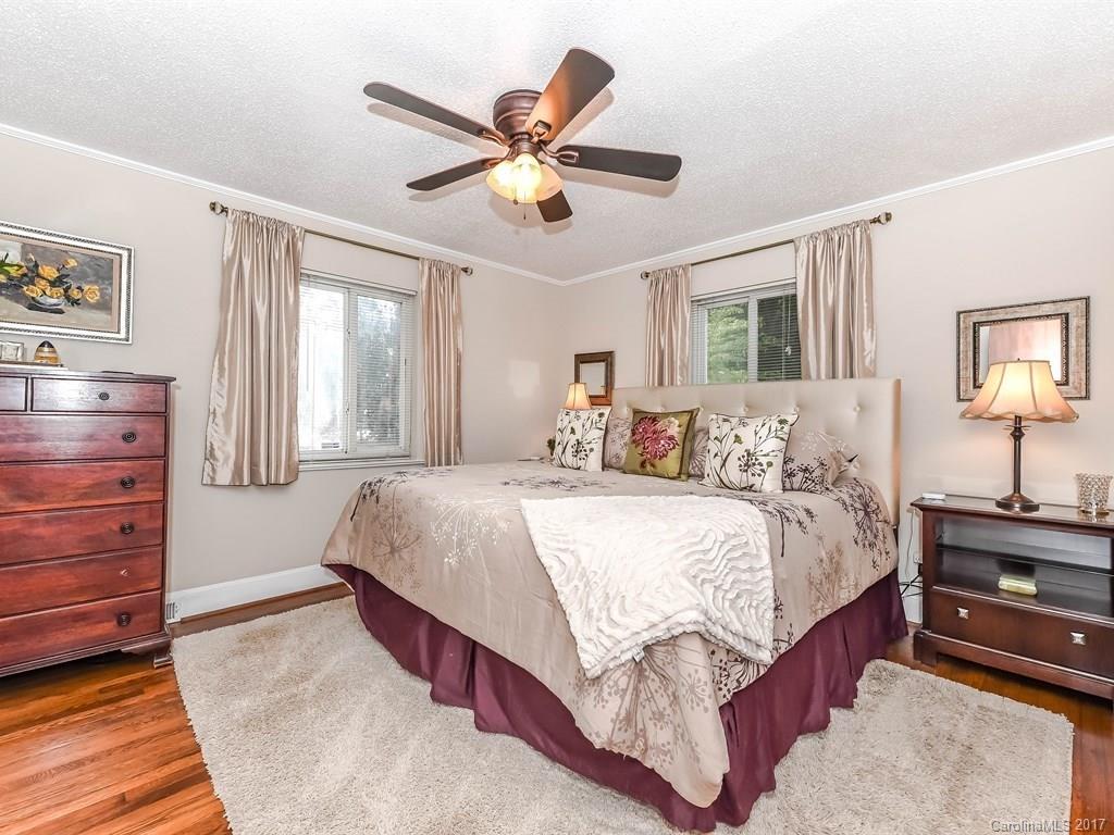 4419 Castleton Road Charlotte, NC 28211 - Photo 14 of 24 a bedroom with a large bed and a chandelier