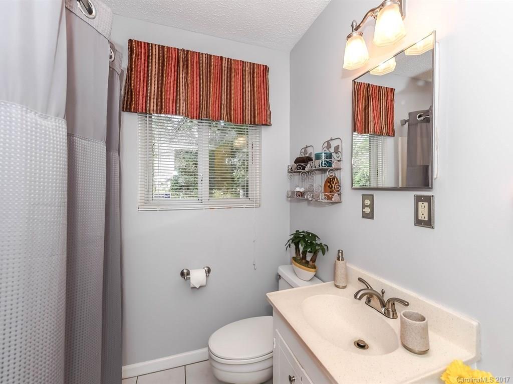 4419 Castleton Road Charlotte, NC 28211 - Photo 16 of 24 a bathroom with a sink a toilet and a mirror