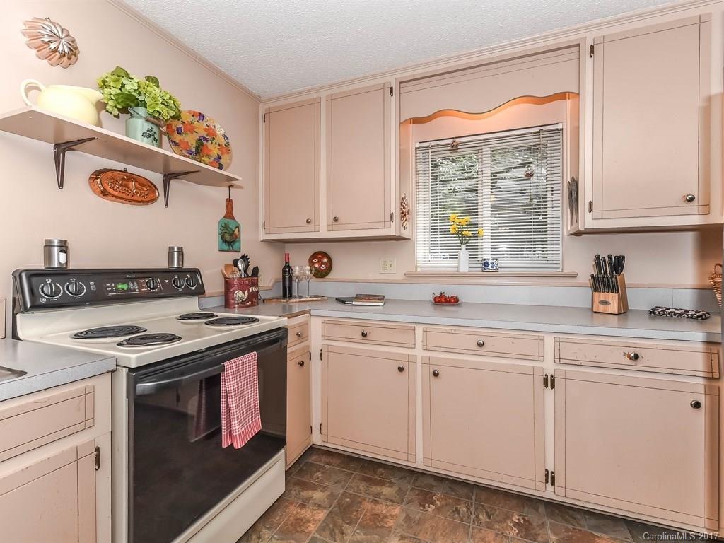 4419 Castleton Road Charlotte, NC 28211 - Photo 10 of 24 a kitchen with stainless steel appliances granite countertop a sink stove and cabinets