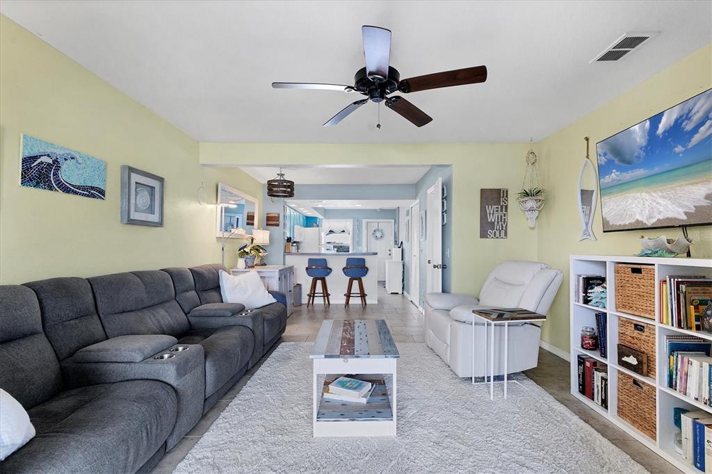 26310 Rampart Boulevard, Unit D504 Punta Gorda, FL 33983 - Photo 11 of 46 a living room with furniture and a book shelf