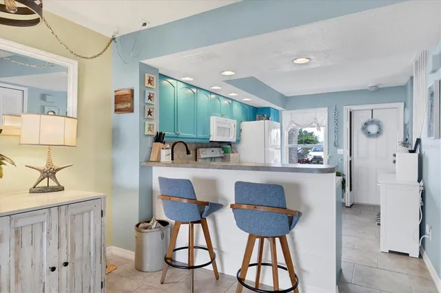 a view of kitchen with dining area and chandelier