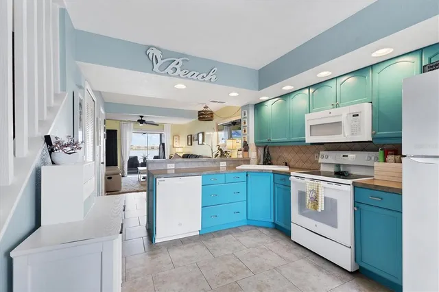a kitchen with cabinets a sink and appliances