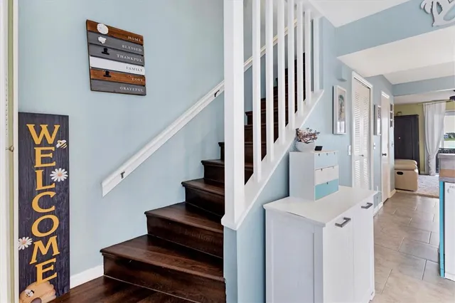 a view of a hallway with wooden floor and staircase