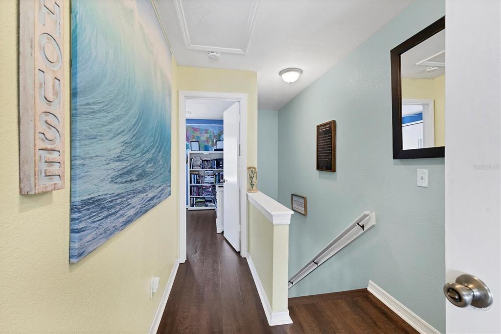 26310 Rampart Boulevard, Unit D504 Punta Gorda, FL 33983 - Photo 20 of 46 a view of a hallway with wooden floor and staircase