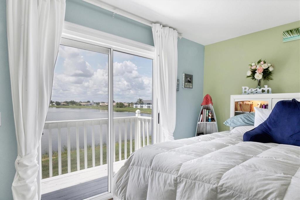 26310 Rampart Boulevard, Unit D504 Punta Gorda, FL 33983 - Photo 22 of 46 a bed sitting in a bedroom next to a window
