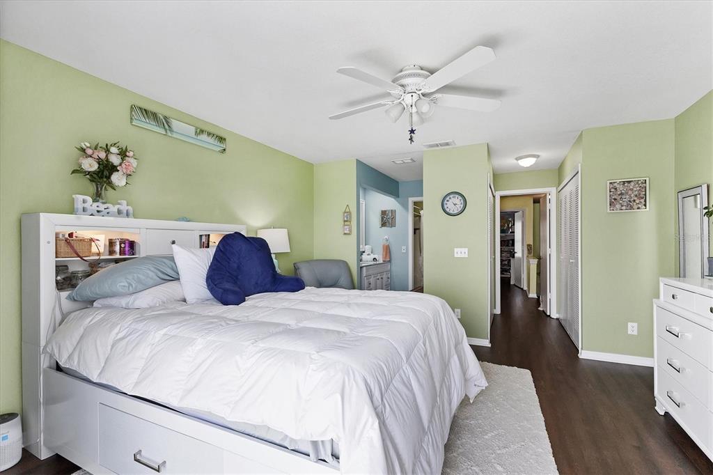 26310 Rampart Boulevard, Unit D504 Punta Gorda, FL 33983 - Photo 23 of 46 a bedroom with a large bed and a chandelier