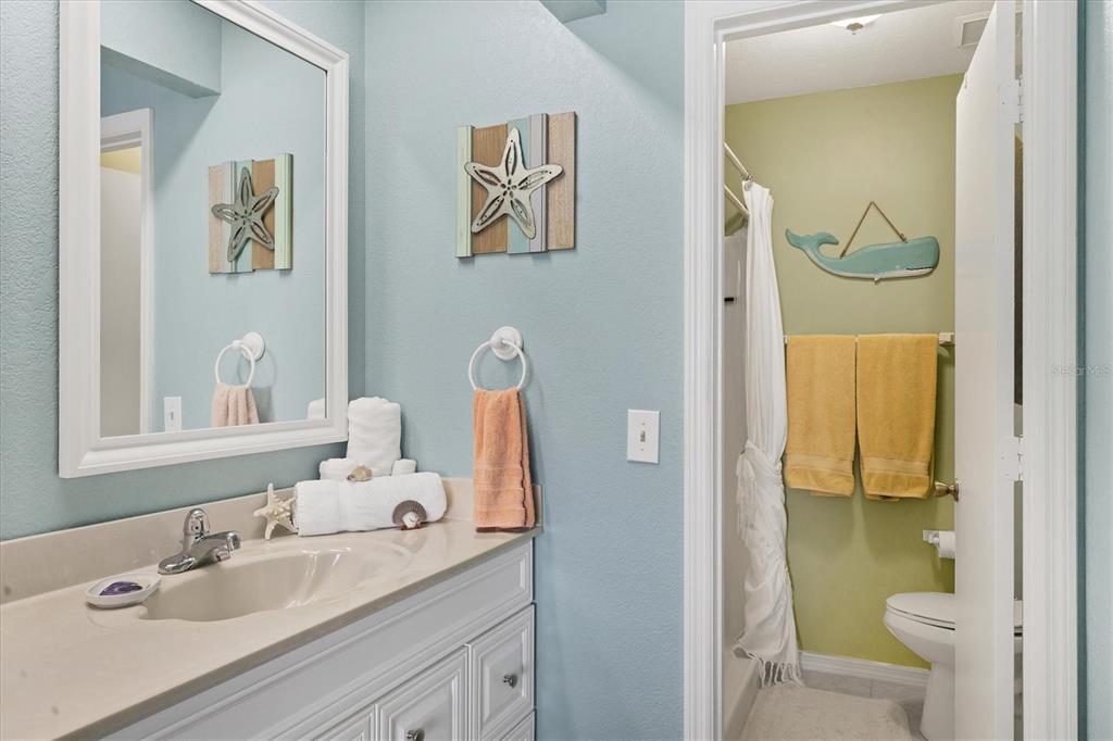 26310 Rampart Boulevard, Unit D504 Punta Gorda, FL 33983 - Photo 26 of 46 a bathroom with a sink a toilet and shower curtain