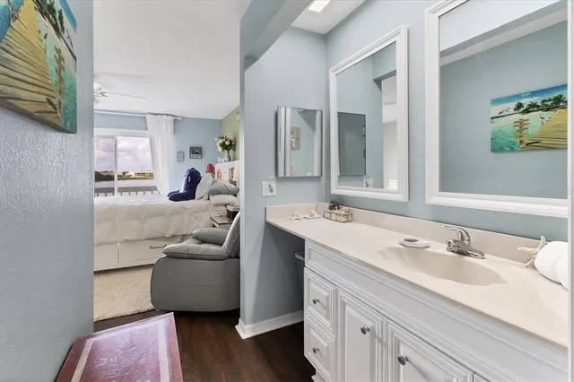 a view of a workspace with furniture and a bookshelf