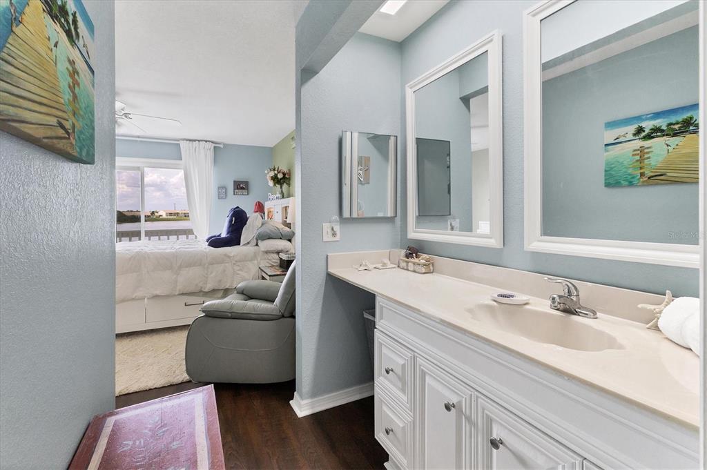 26310 Rampart Boulevard, Unit D504 Punta Gorda, FL 33983 - Photo 27 of 46 a en suite bathroom with a granite countertop sink and a mirror