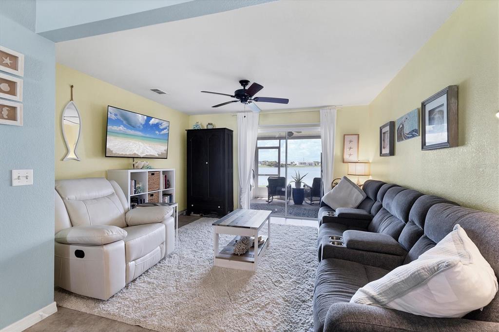 26310 Rampart Boulevard, Unit D504 Punta Gorda, FL 33983 - Photo 10 of 46 a living room with furniture and a large window