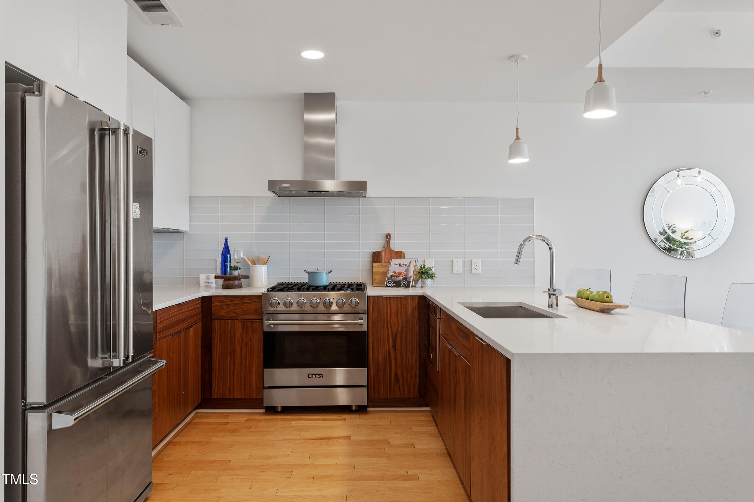 523 South West Street, Unit 404 Raleigh, NC 27601 - Photo 9 of 34 a kitchen with stainless steel appliances granite countertop a sink stove and refrigerator