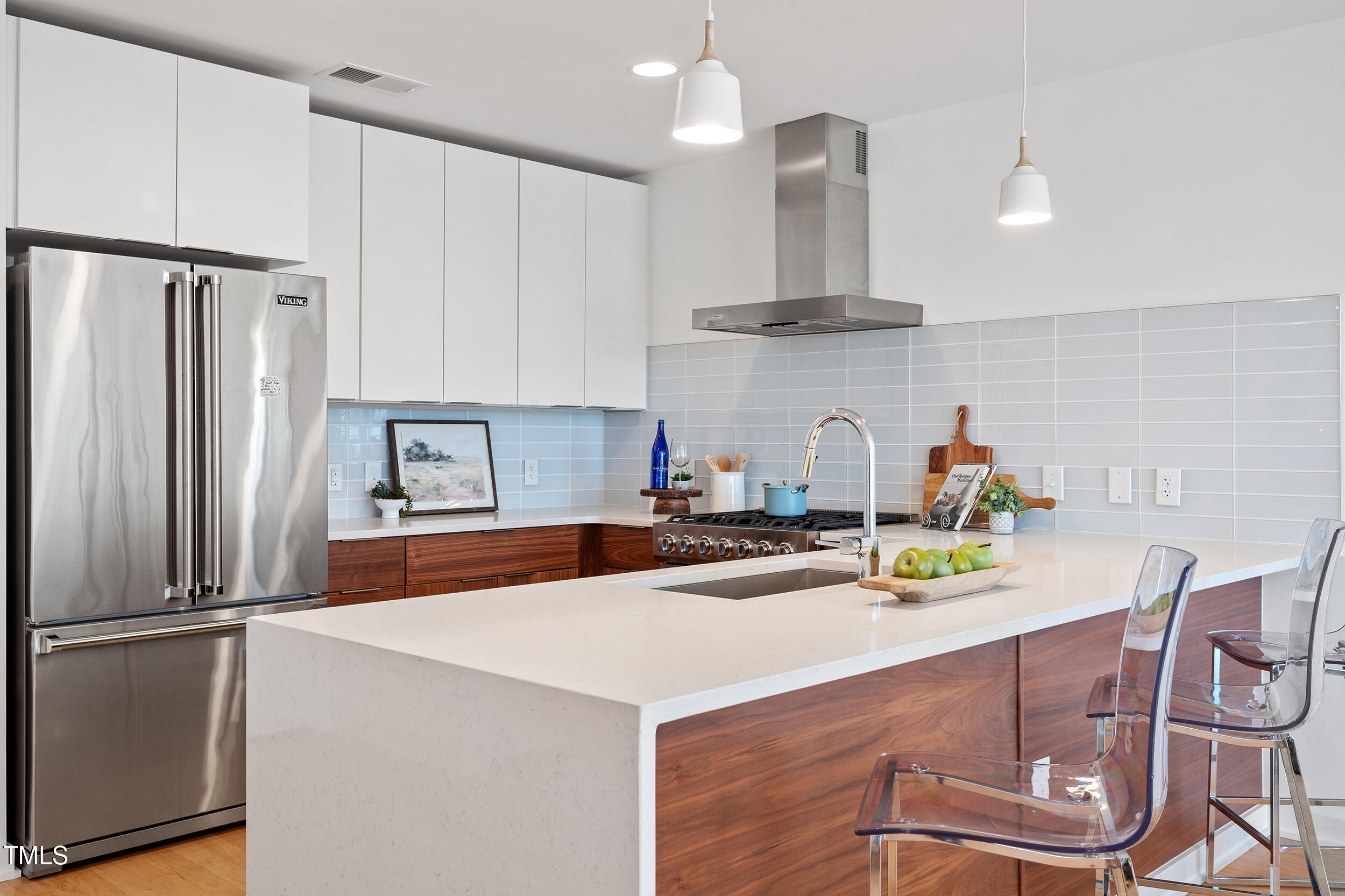523 South West Street, Unit 404 Raleigh, NC 27601 - Photo 11 of 34 a kitchen with stainless steel appliances a sink a stove a refrigerator and cabinets
