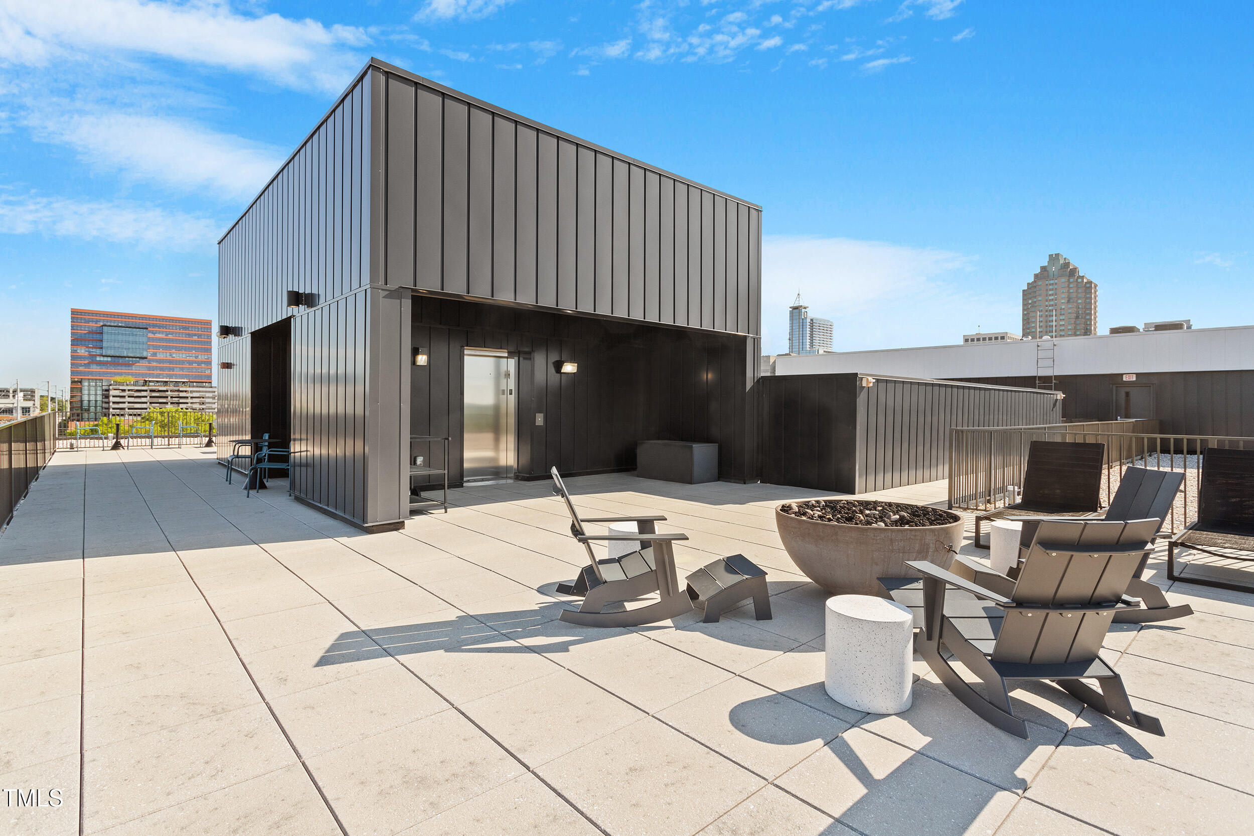 523 South West Street, Unit 404 Raleigh, NC 27601 - Photo 29 of 34 a view of a patio with table and chairs and potted plants