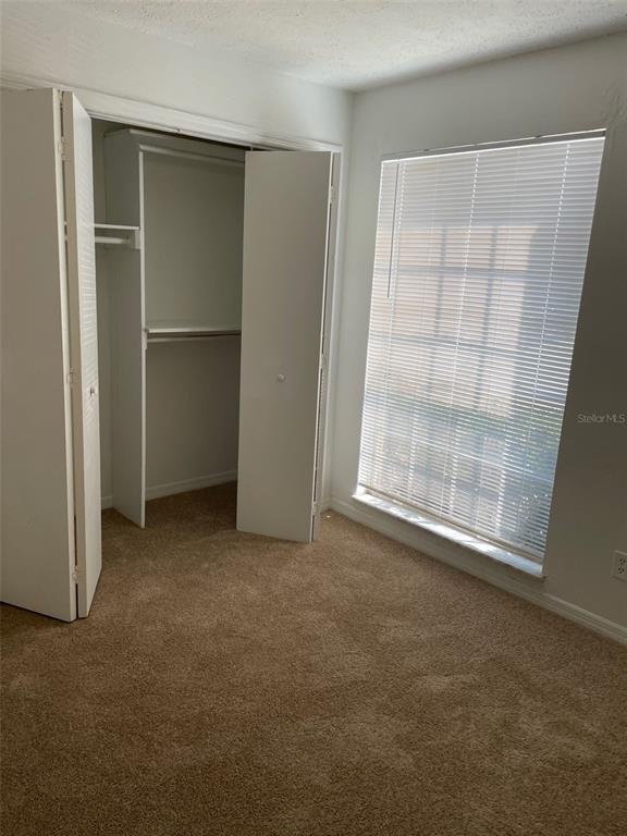 415 Wymore Road, Unit 101 Altamonte Springs, FL 32714 - Photo 15 of 15 an empty room with windows and closet