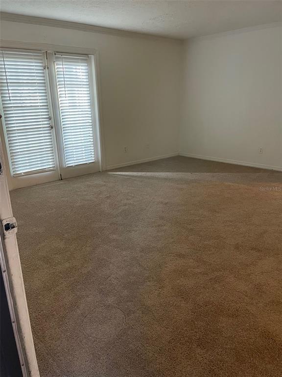 415 Wymore Road, Unit 101 Altamonte Springs, FL 32714 - Photo 7 of 15 an empty room with windows