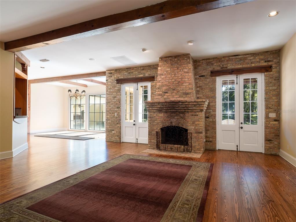 950 Southwest 43rd Place Ocala, FL 34471 - Photo 13 of 42 a living room with a fireplace and wooden floor