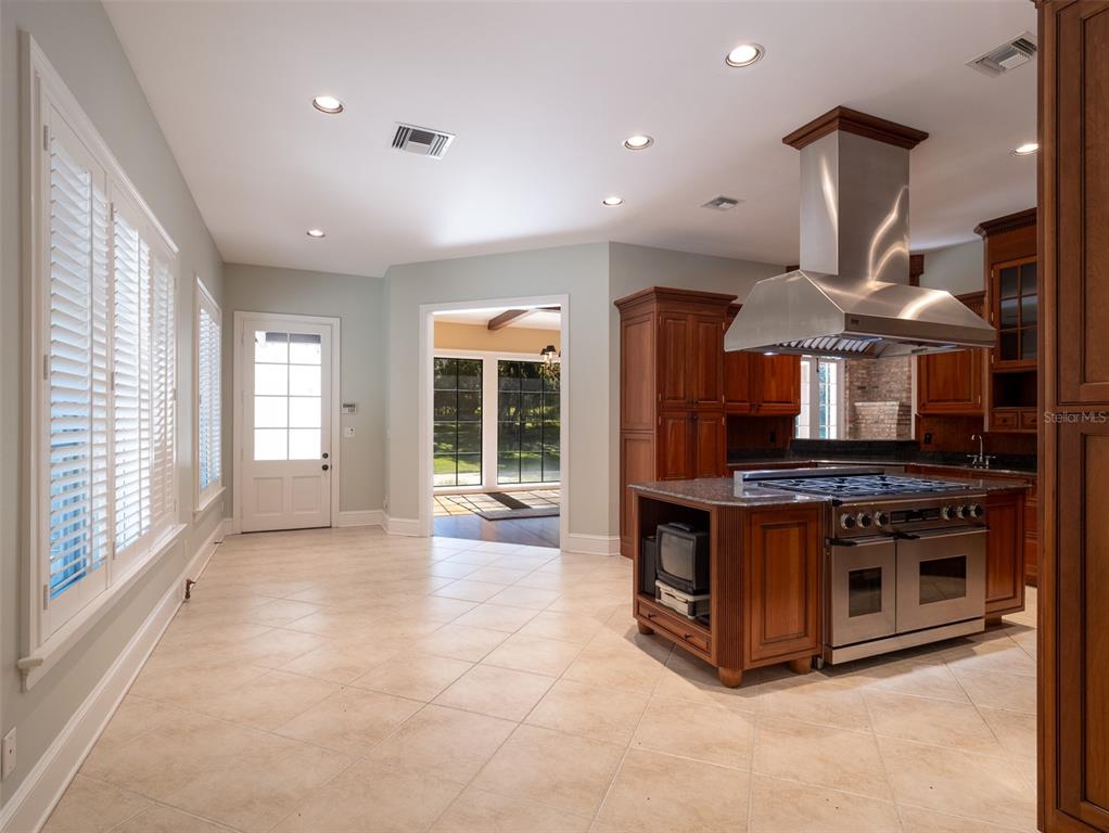 950 Southwest 43rd Place Ocala, FL 34471 - Photo 15 of 42 a kitchen with stainless steel appliances granite countertop a stove and a sink