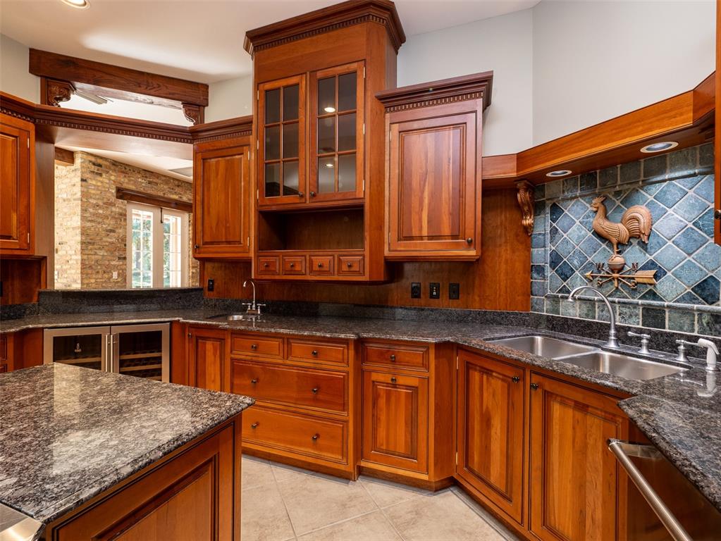 950 Southwest 43rd Place Ocala, FL 34471 - Photo 17 of 42 a kitchen with stainless steel appliances granite countertop a sink stove and cabinets