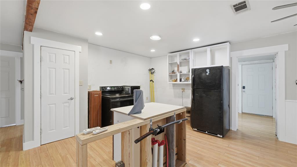 655 Northwest Nw Loop Smithville, TX 78957 - Photo 12 of 13 a kitchen with stainless steel appliances granite countertop a refrigerator a stove and a wooden floors