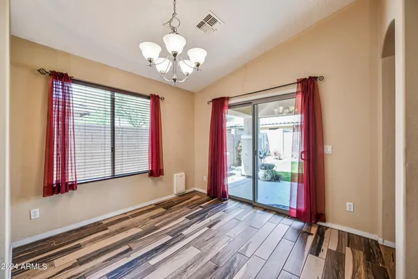 a view of a room with wooden floor and windows