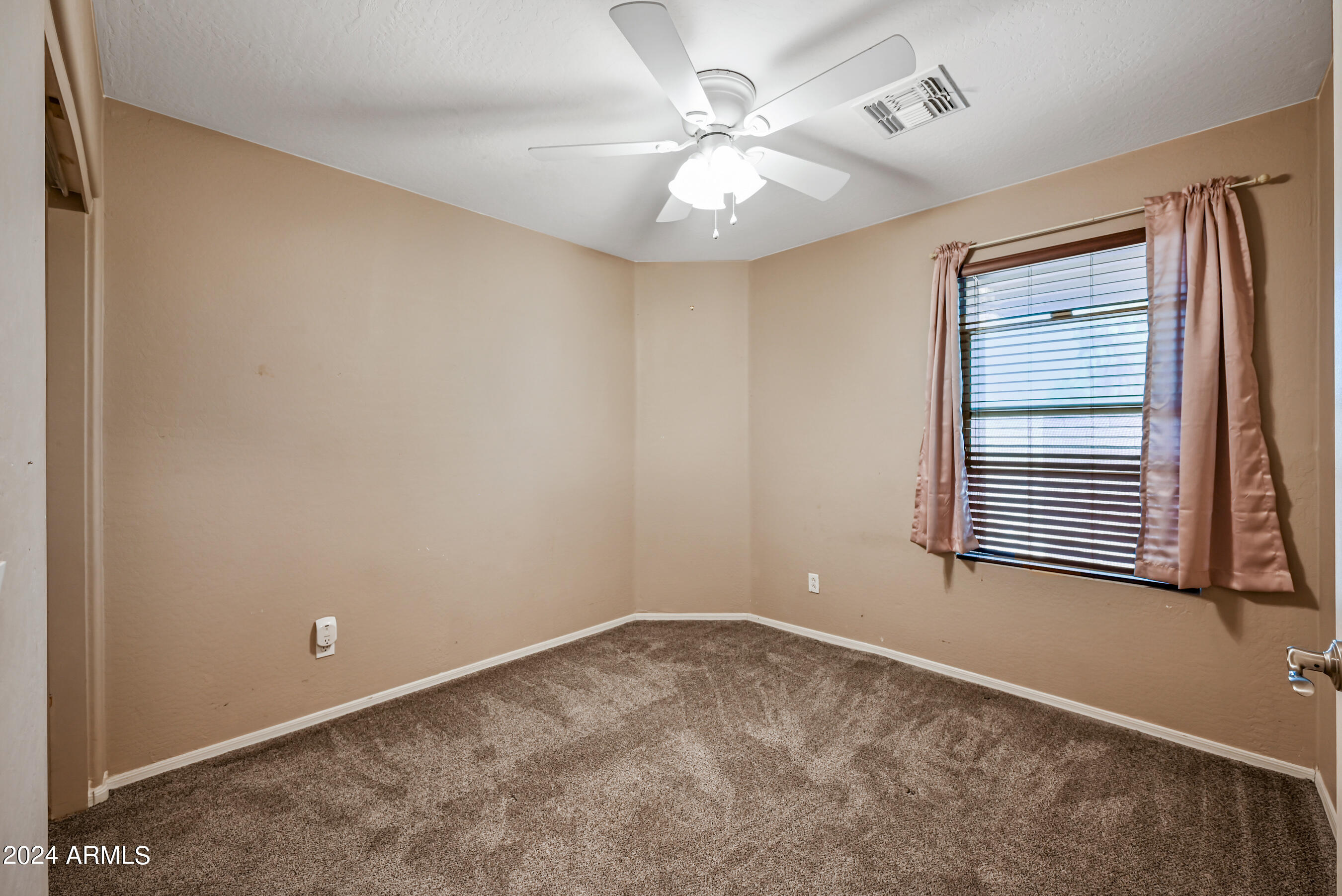 2992 East Blue Ridge Way Gilbert, AZ 85298 - Photo 18 of 25 a view of a livingroom with a ceiling fan and window