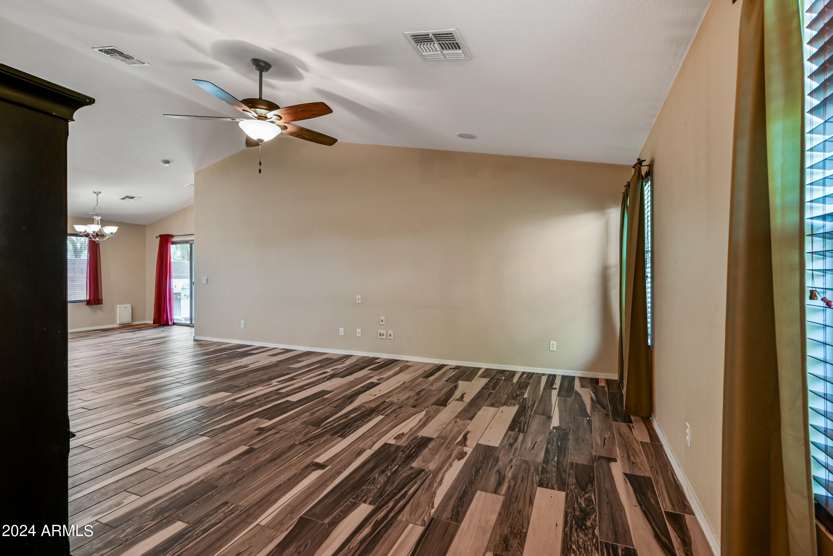 2992 East Blue Ridge Way Gilbert, AZ 85298 - Photo 2 of 25 a view of an empty room with wooden floor and a window