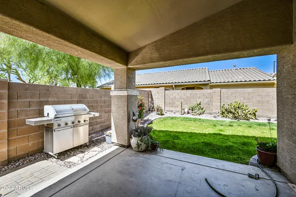 a backyard of a house with yard table and chairs
