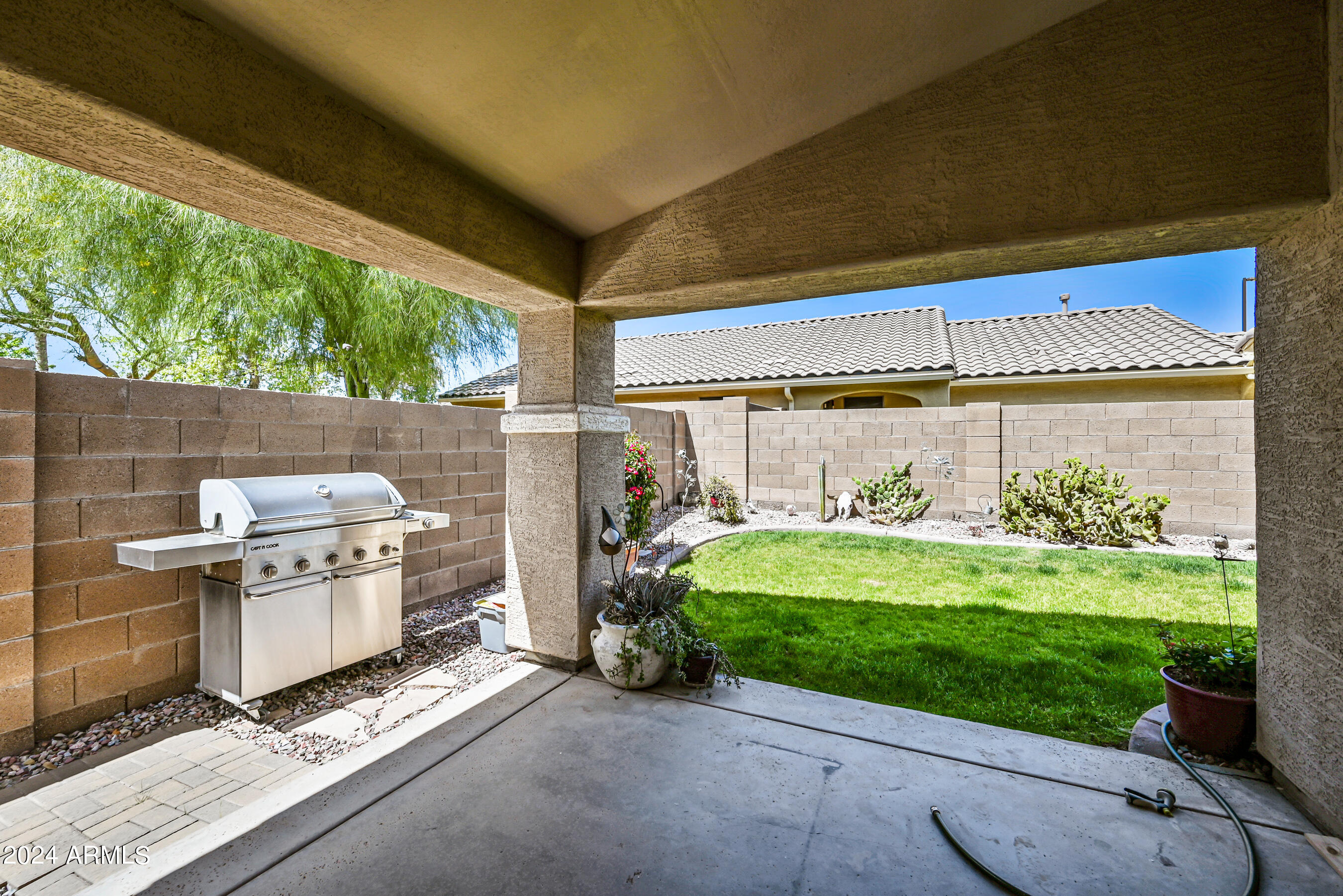 2992 East Blue Ridge Way Gilbert, AZ 85298 - Photo 23 of 25 a backyard of a house with yard table and chairs