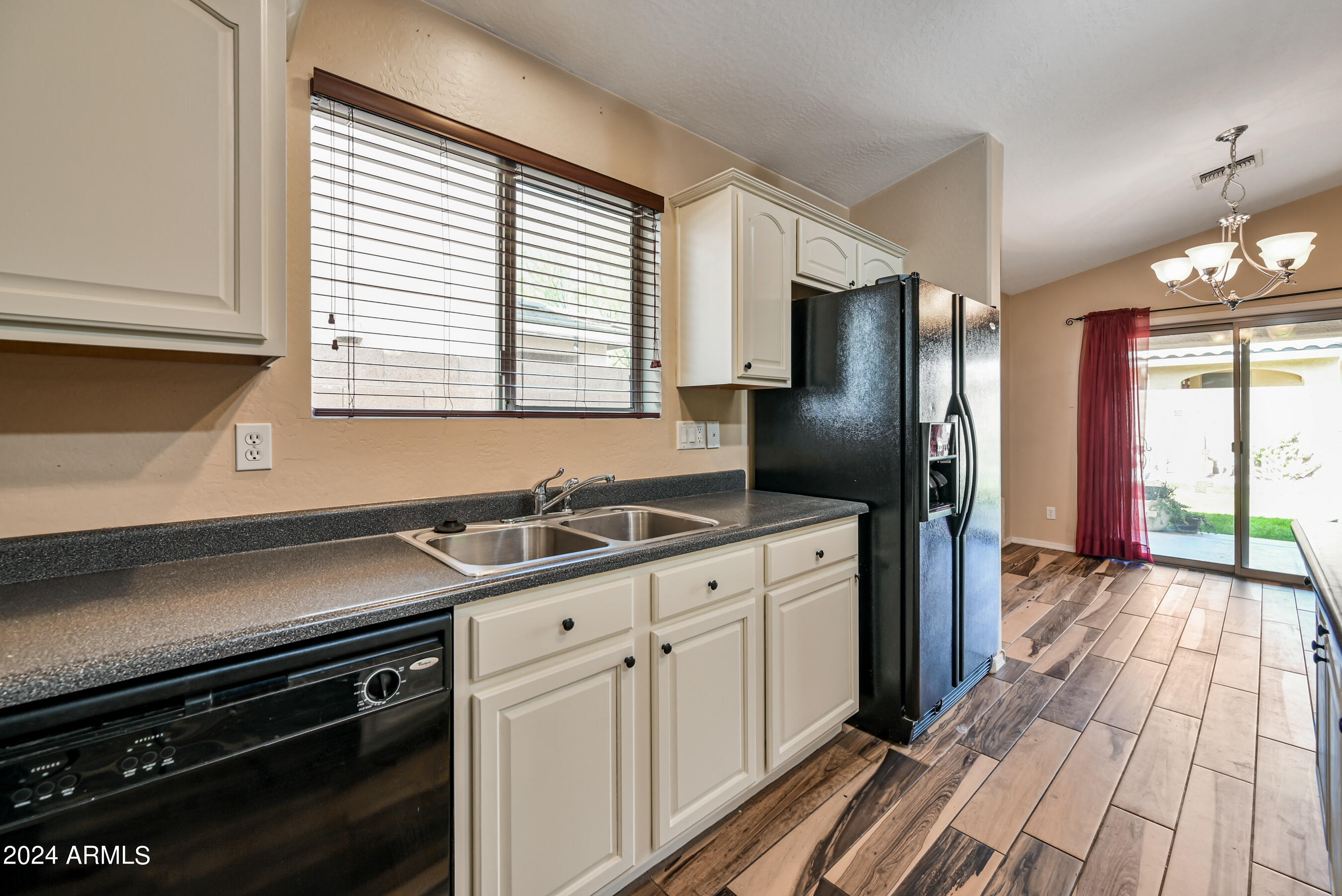 2992 East Blue Ridge Way Gilbert, AZ 85298 - Photo 9 of 25 a kitchen with stainless steel appliances a sink stove and refrigerator