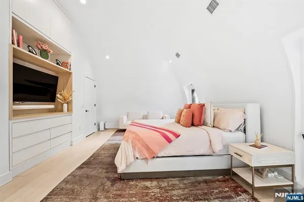 a room that has a bed mirror and a window