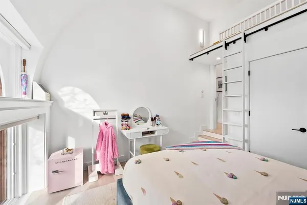 a bedroom with a bed and a chair