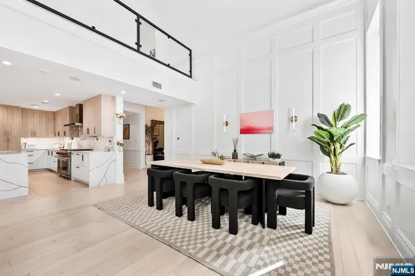 a living room with stainless steel appliances kitchen island granite countertop furniture and a dining table