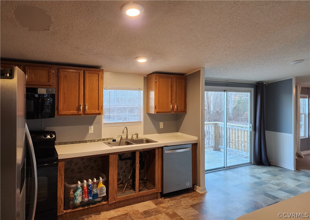 1609 Jeter Road Powhatan, VA 23139 - Photo 12 of 30 a hall with stainless steel appliances granite countertop a stove a sink dishwasher and a refrigerator with wooden floor