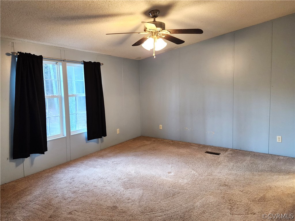 1609 Jeter Road Powhatan, VA 23139 - Photo 16 of 30 an empty room with fan and windows
