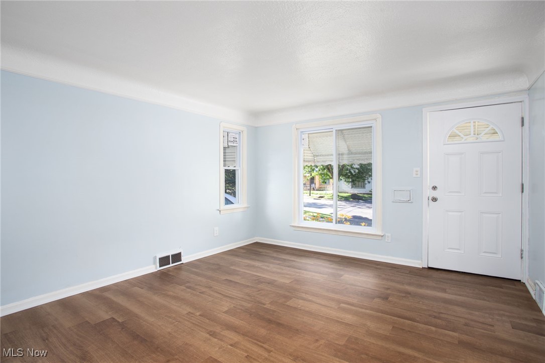 12028 Triskett Road Cleveland, OH 44111 - Photo 7 of 23 Entrance foyer featuring dark wood-type flooring and baseboards