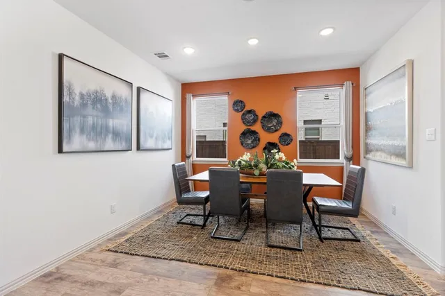 a dining room with furniture and wooden floor