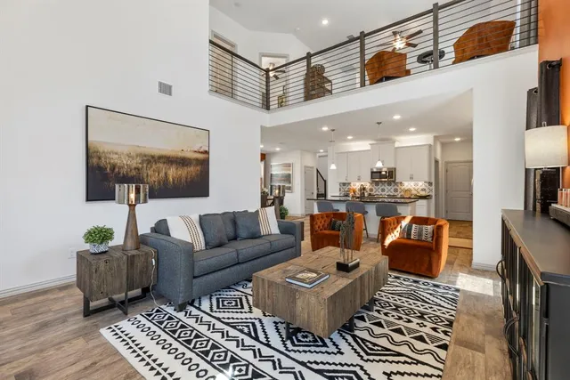 a living room with furniture and a view of kitchen