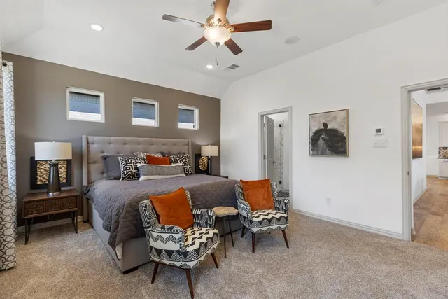 a bedroom with furniture and a ceiling fan