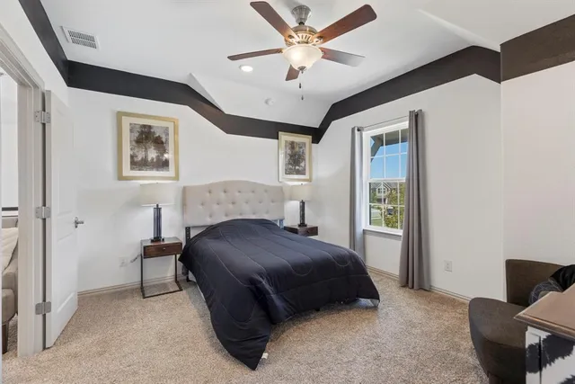 a bedroom with a bed and a chair