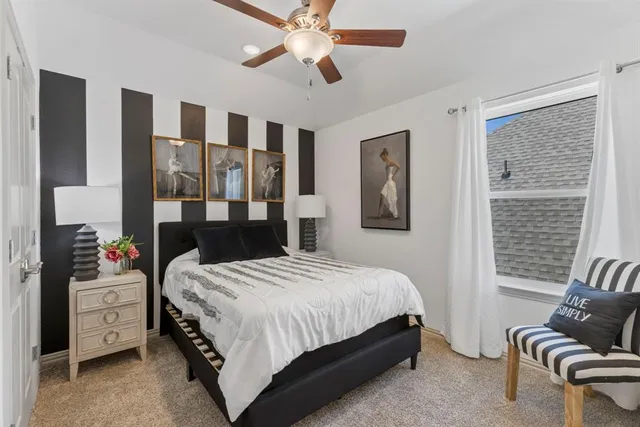 a bedroom with a bed couch and window