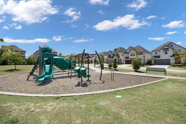a view of outdoor space with playground and green space
