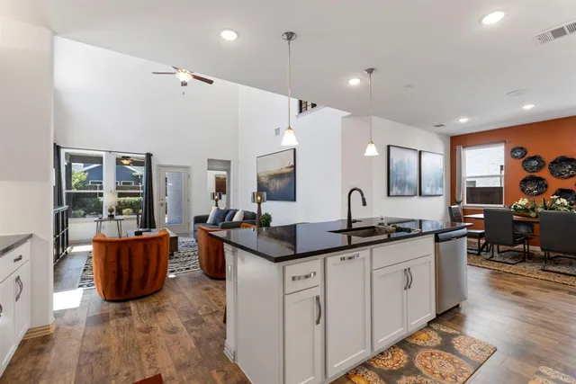 a kitchen with stainless steel appliances granite countertop a sink and cabinets