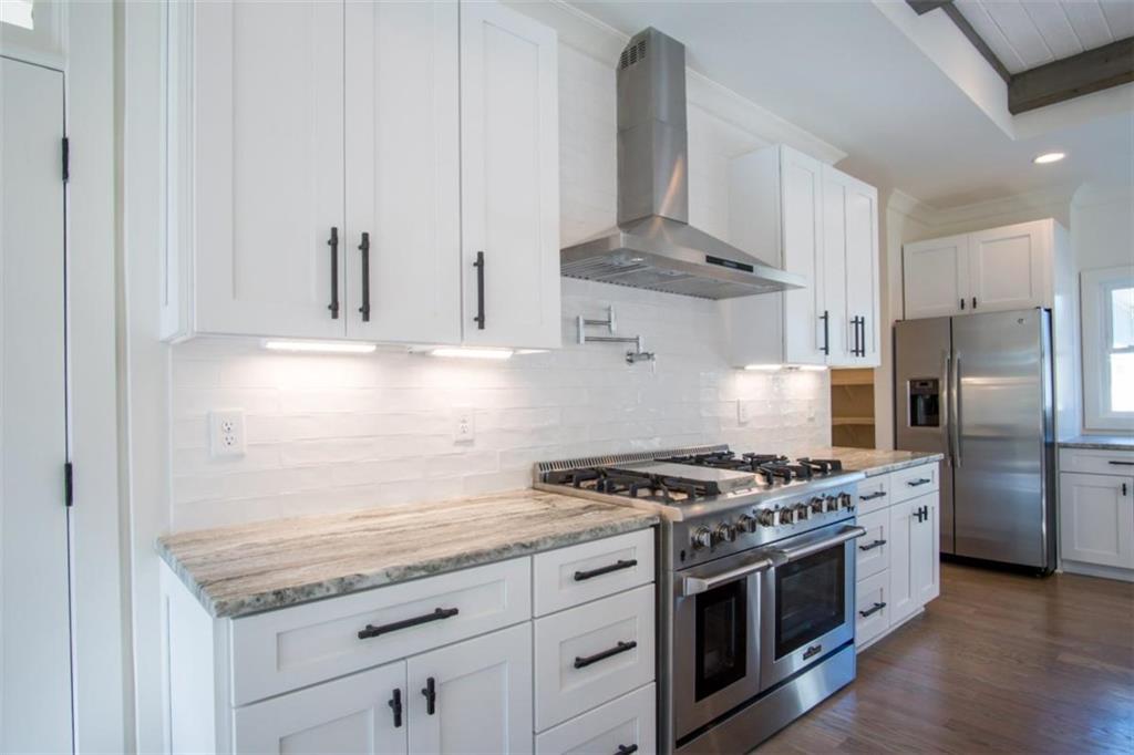 Lot 3 Cox Road Roswell, GA 30075 - Photo 28 of 37 a kitchen with stainless steel appliances granite countertop a stove a refrigerator and a granite counter tops