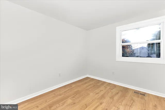 a view of an empty room and wooden floor
